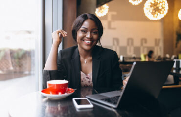 Business Woman Using Laptop and Mobile Phone