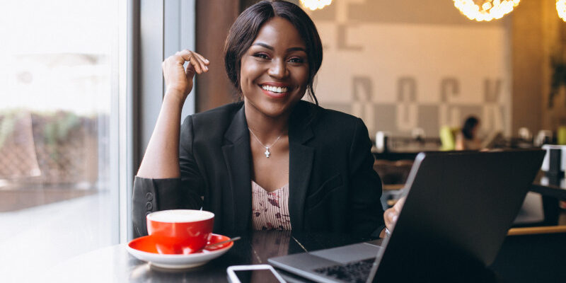 Business Woman Using Laptop and Mobile Phone