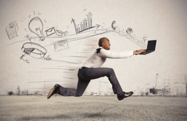 Man Using Laptop Whilst Running