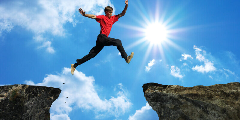 Man Jumping Between High Rocks With Big Gap In-between