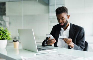 Man Using Credit Card On Laptop and Mobile