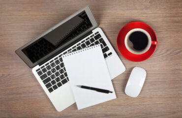 Laptop, Notepad and Pen Next To Cup Of Coffee