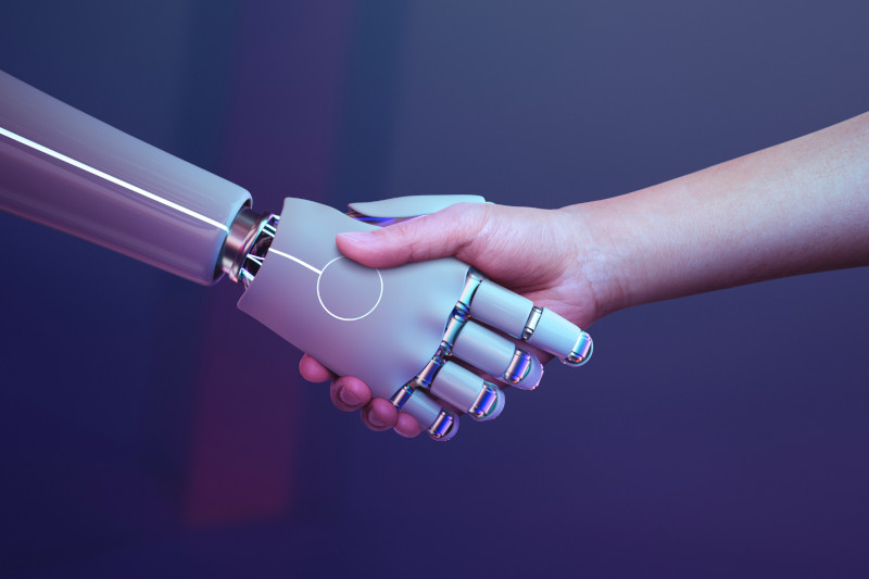 Robot hand shaking human hand