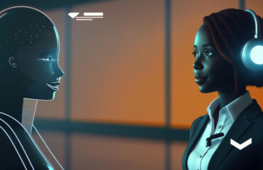 A robot and a woman facing each other, the woman has headphones and a mic attached to her shirt