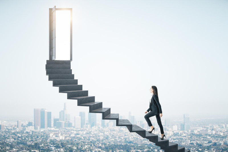 Businesswoman walking on ladder to success with megapolis city backdrop