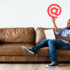 Man working on laptop whilst sitting on couch