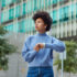 Young woman looking the other way from her wristwatch