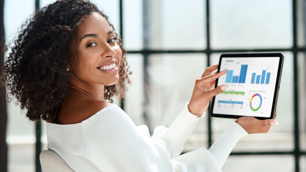 Smiling business woman with a digital tablet looking at the camera