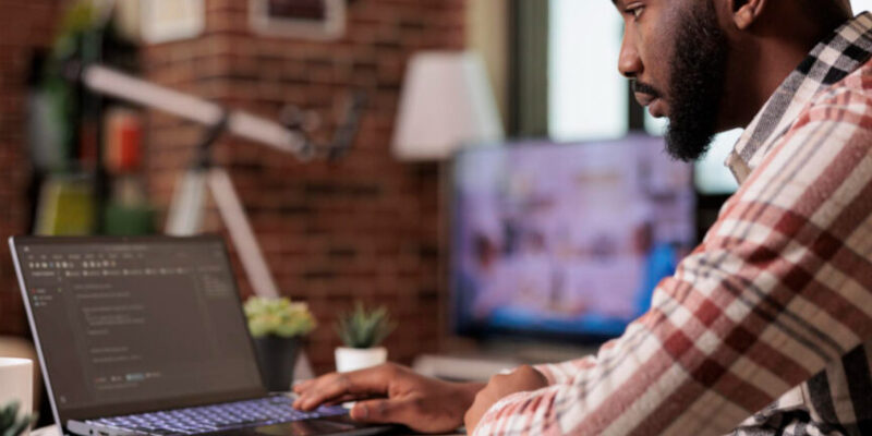 Man coding on laptop