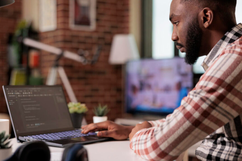 Man coding on laptop