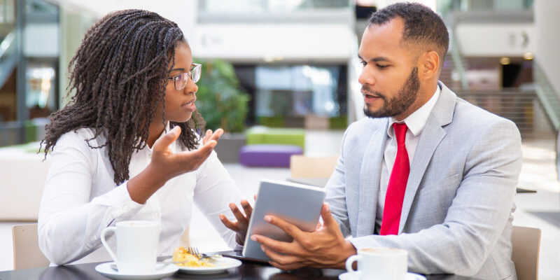 Businessman showing project presentation to female client