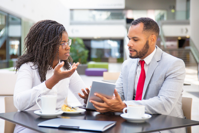 Businessman showing project presentation to female client