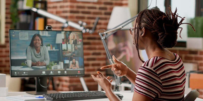 Employee attending video call business meeting on computer with webcam