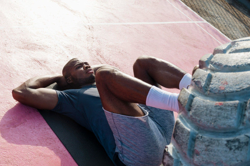 Man training using big and heavy tyre