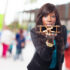 Woman with a wooden plane in her hand, blowing at it