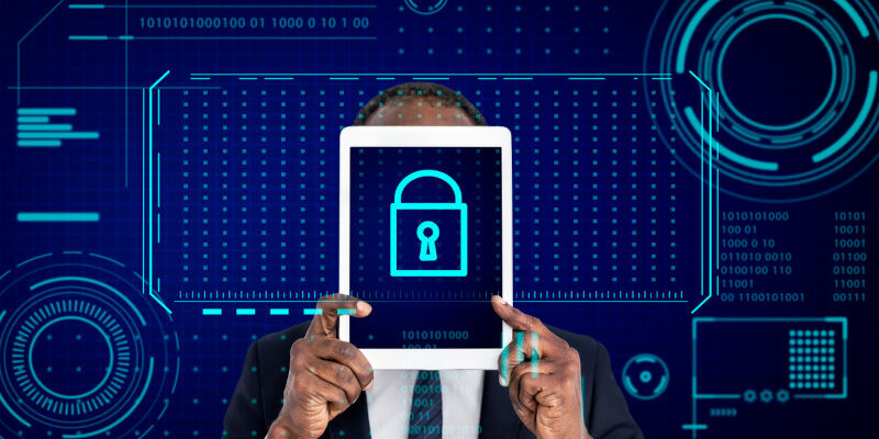 Man in suit holding tablet with Key lock password icon on it and tech security graphics in background