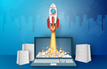 Business concept, Rocket launching from laptop with paper bags around