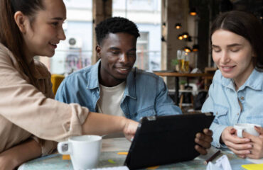Business people discussing a project whilst looking at a tablet