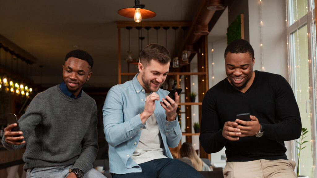 young males looking at mobiles