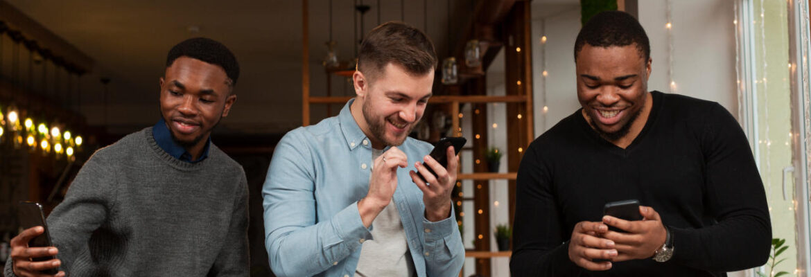 young males looking at mobiles