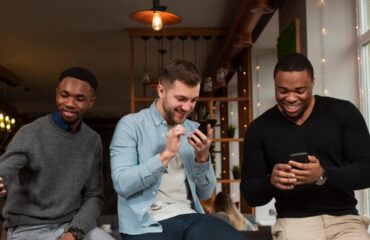 young males looking at mobiles
