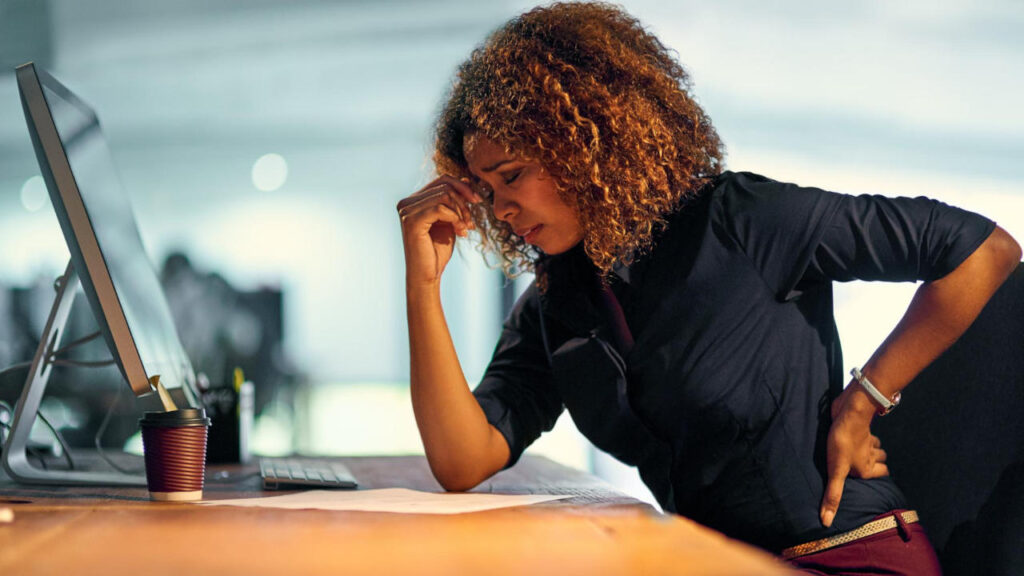 A demotivated businesswoman sitting at her desk