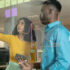 Young colleagues planning strategy over glass wall at modern workplace