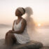 A cinematic illustration of an African woman sitting calmly on a rock at sunrise