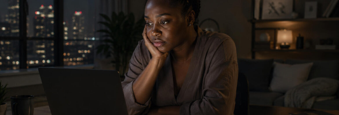 Young woman contemplating work in a city night